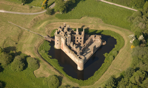 An aerial view of the unusual triangle-shaped Caerlaverock Castle in Dumfries and Galloway.